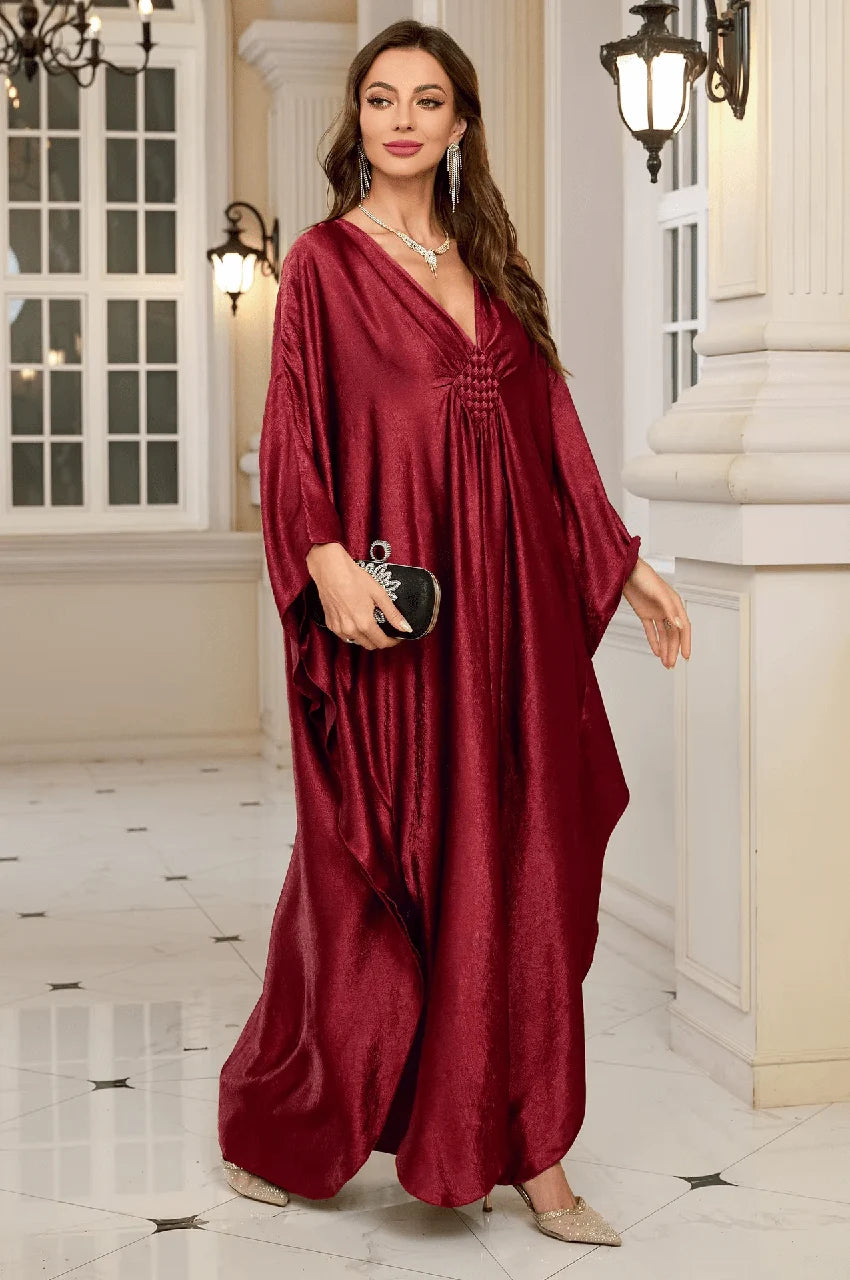 Woman walking in Inara red batwing kaftan styled for evening occasion