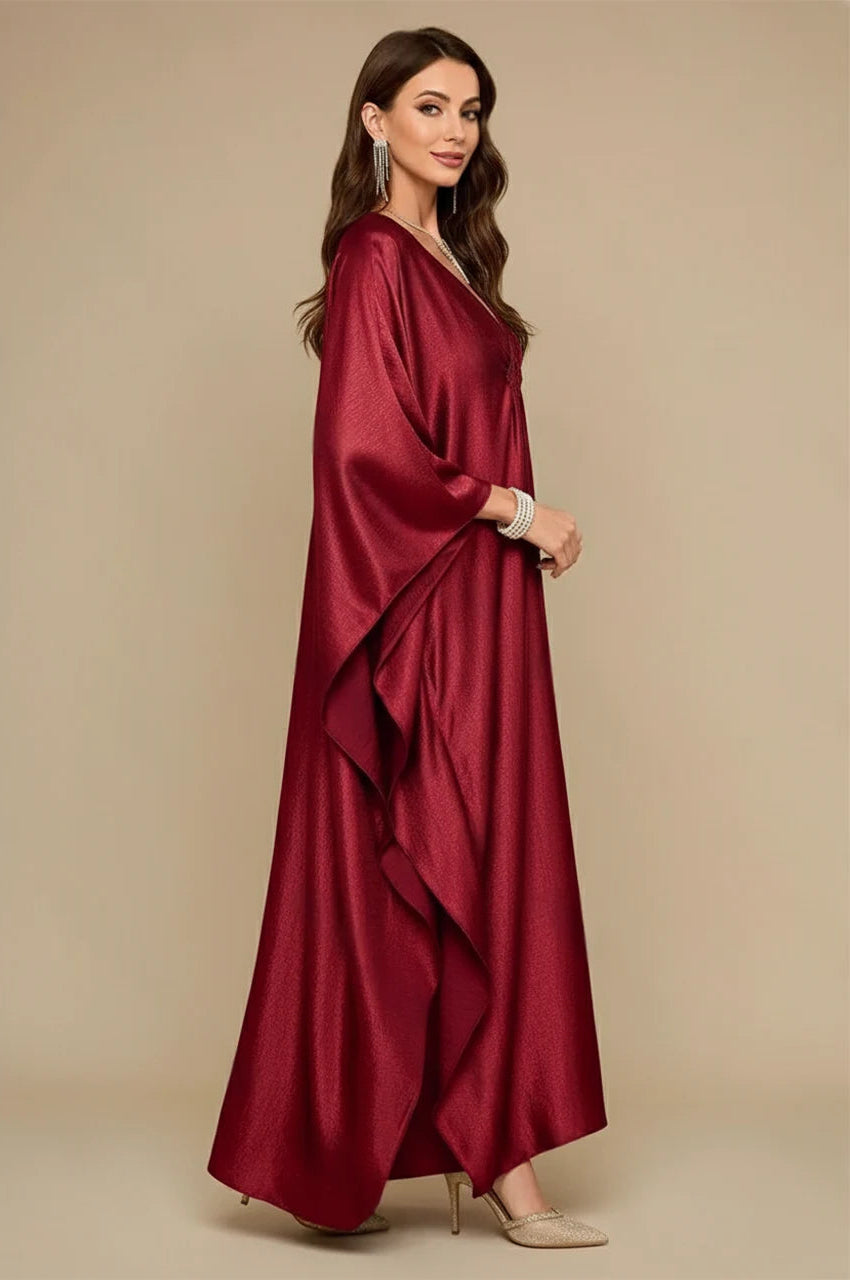 Inara red batwing kaftan side view showing cascading draped sleeves and luxe evening design