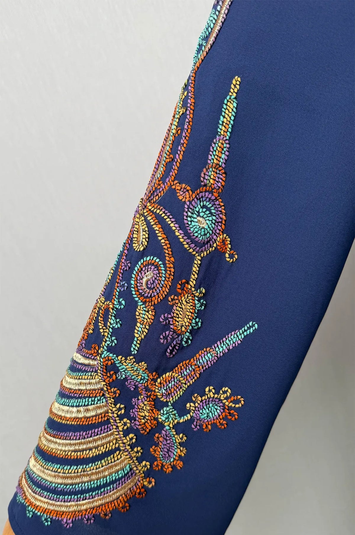 Detailed close-up zoom of the traditional embroidery patterns on the bell sleeve of the Inez Blue Jalabiya Kaftan.