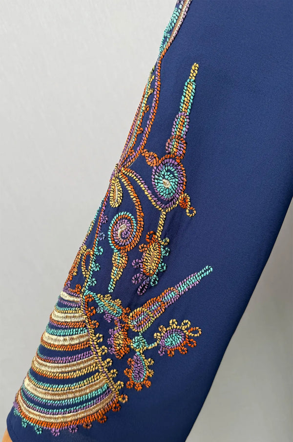 Detailed close-up zoom of the traditional embroidery patterns on the bell sleeve of the Inez Blue Jalabiya Kaftan.