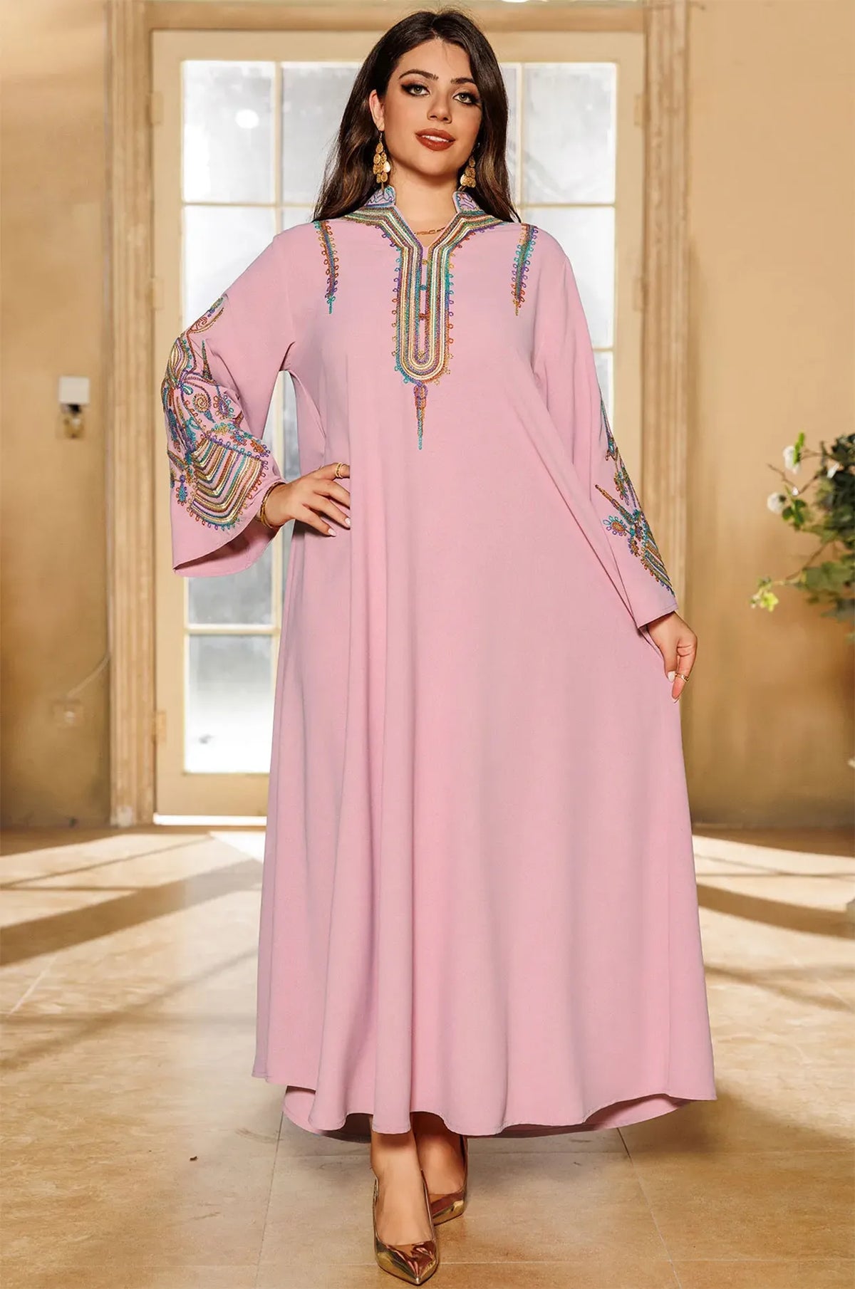 Model posing in the Inez Pink Jalabiya Kaftan with hand on hip to demonstrate the lightweight and breathable fabric.
