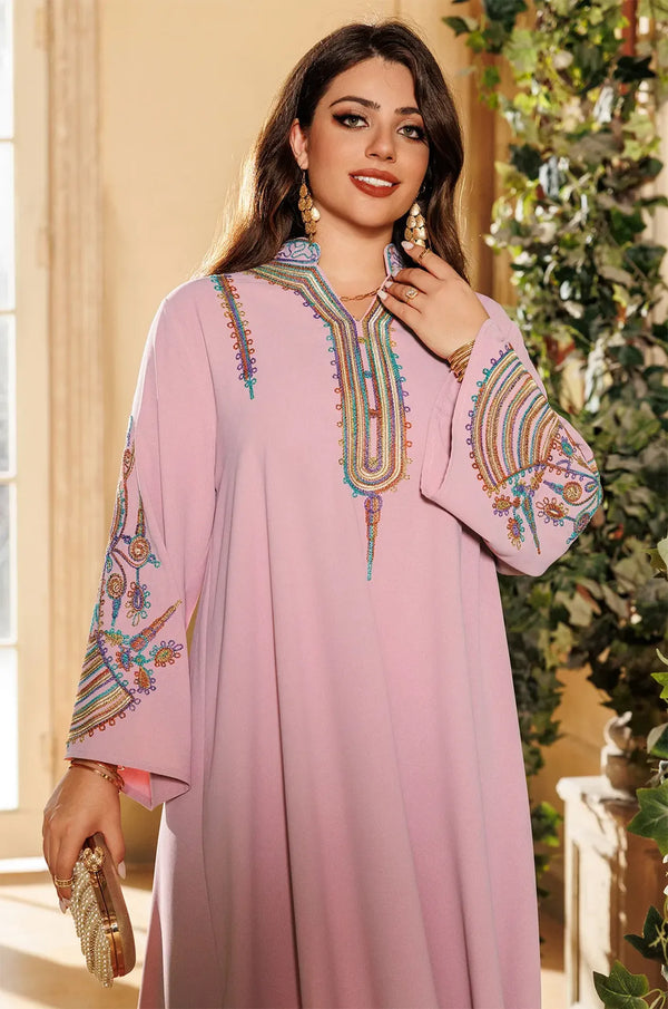 Portrait shot of the Inez Pink Kaftan focusing on the high-collar design and artisanal rainbow embroidery.