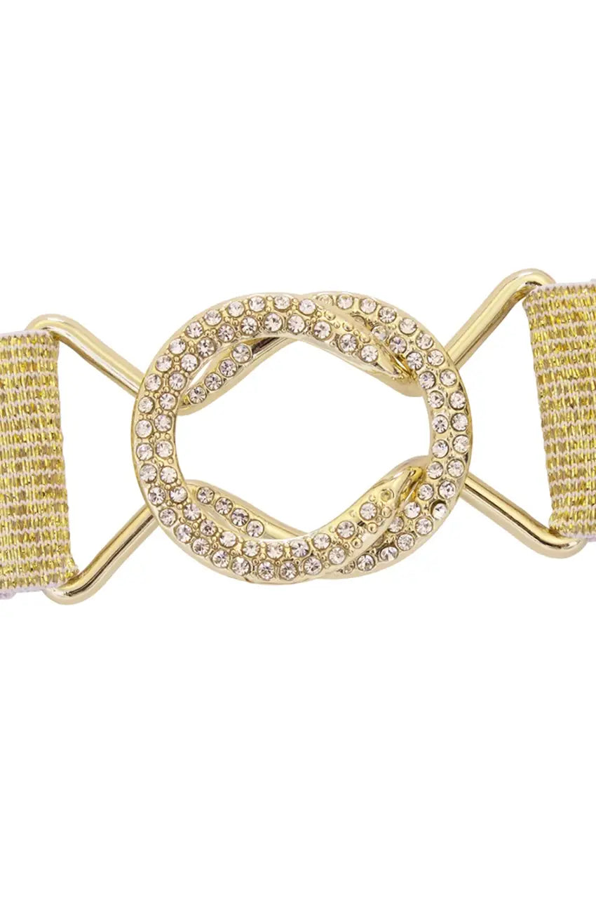 Close-up of gold interlocking belt buckle encrusted with clear rhinestones.