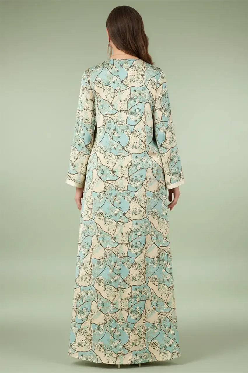 Back view of the Isara green casual Moroccan kaftan highlighting the continuous floral pattern and modest maxi silhouette.