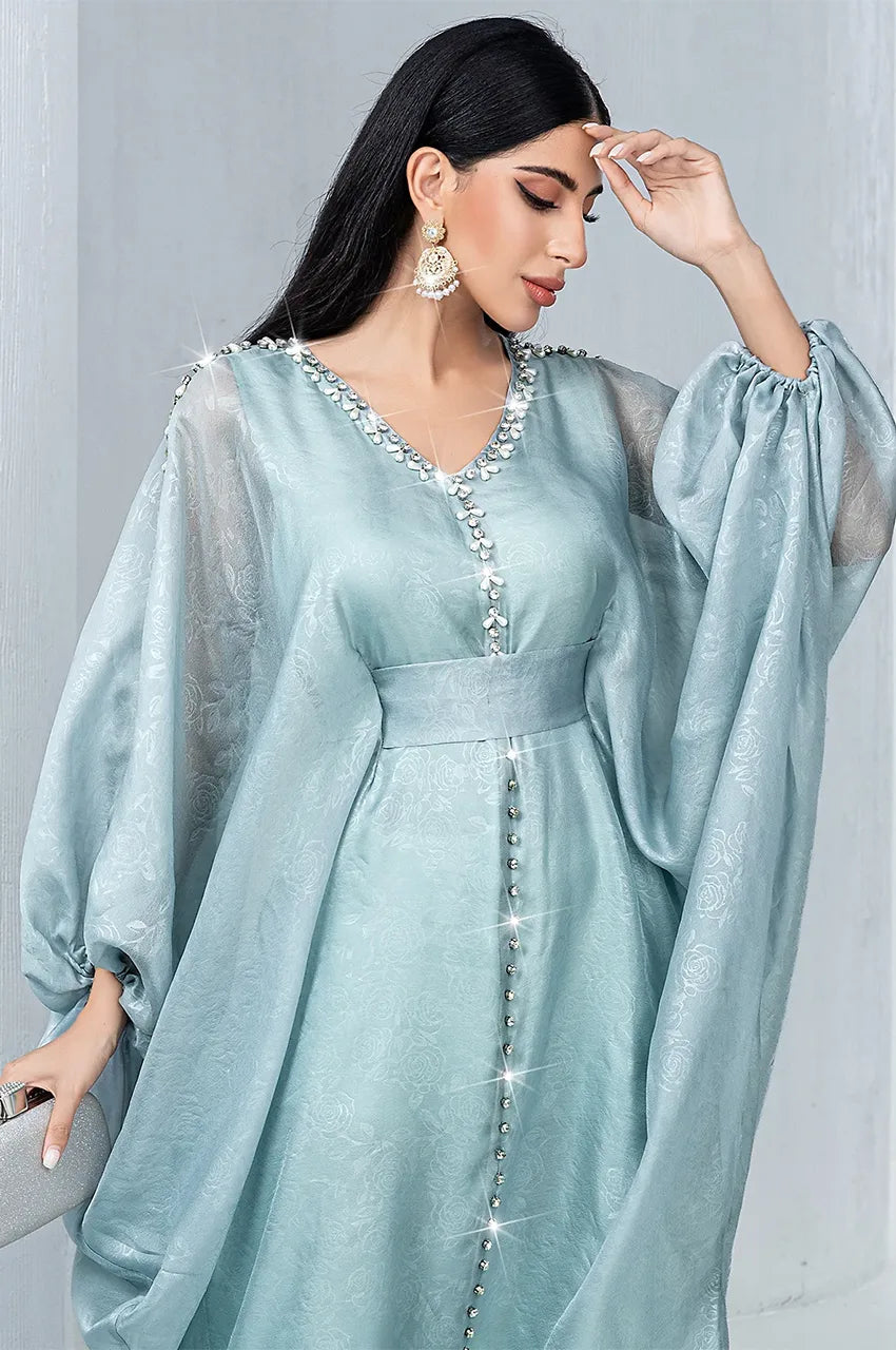 Detailed view of V-neck embroidery on light blue jacquard chiffon kaftan
