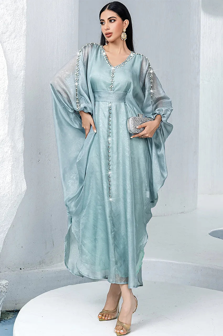 Editorial shot of Jalya light blue moroccan kaftan in a white architectural setting