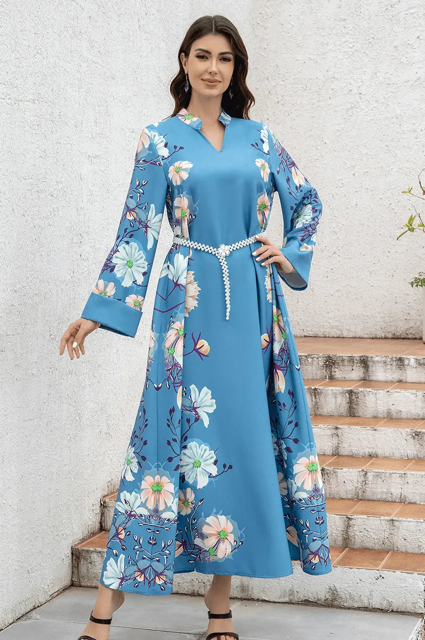 Model wearing elegant blue floral kaftan suitable for summer party.
