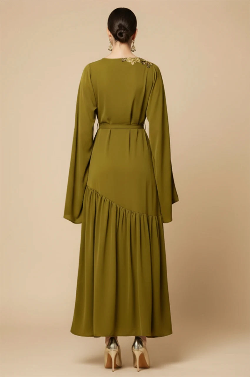 Full back view of the Kairin dress showing the belted waist and floor length fit.