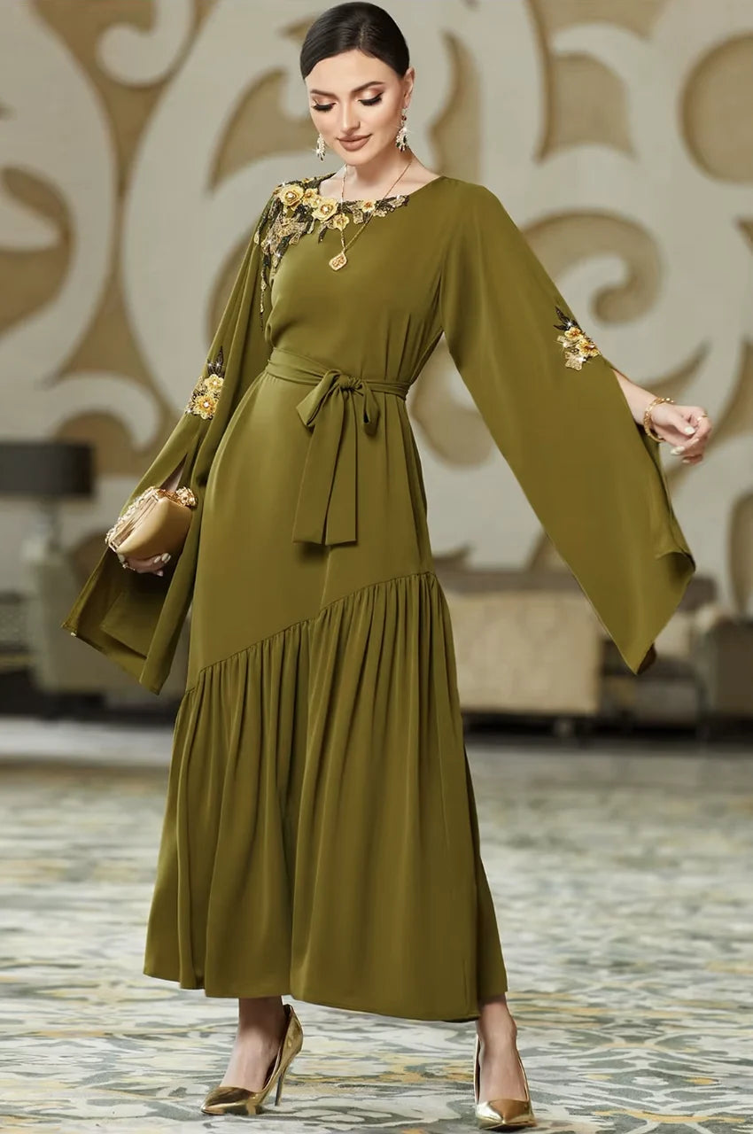 Model walking in the Kairin olive green kaftan showing the flow of the split sleeves.