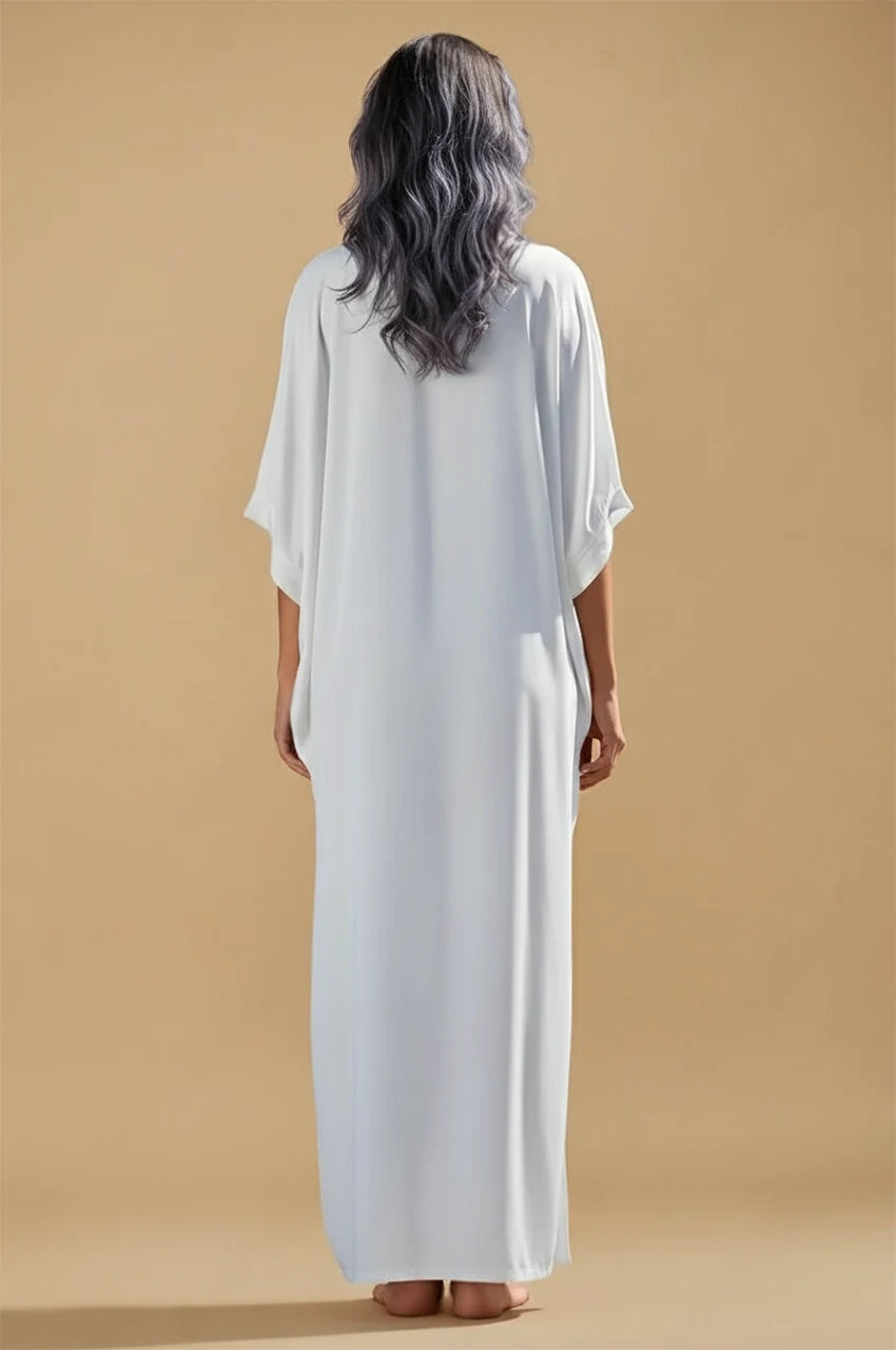 Back view of Kalila white Greek kaftan with relaxed draped fit