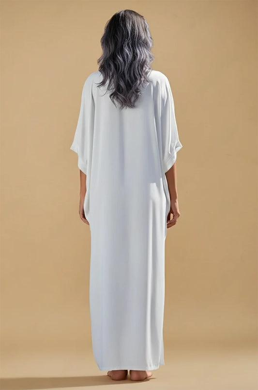 Back view of Kalila white Greek kaftan with relaxed draped fit