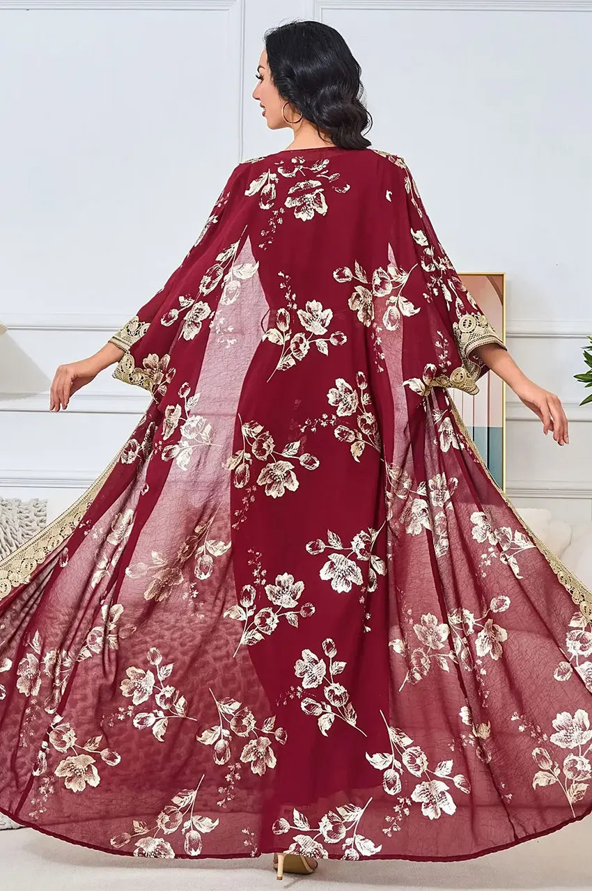 Back view of Kalima kaftan with arms extended showing floral placement.