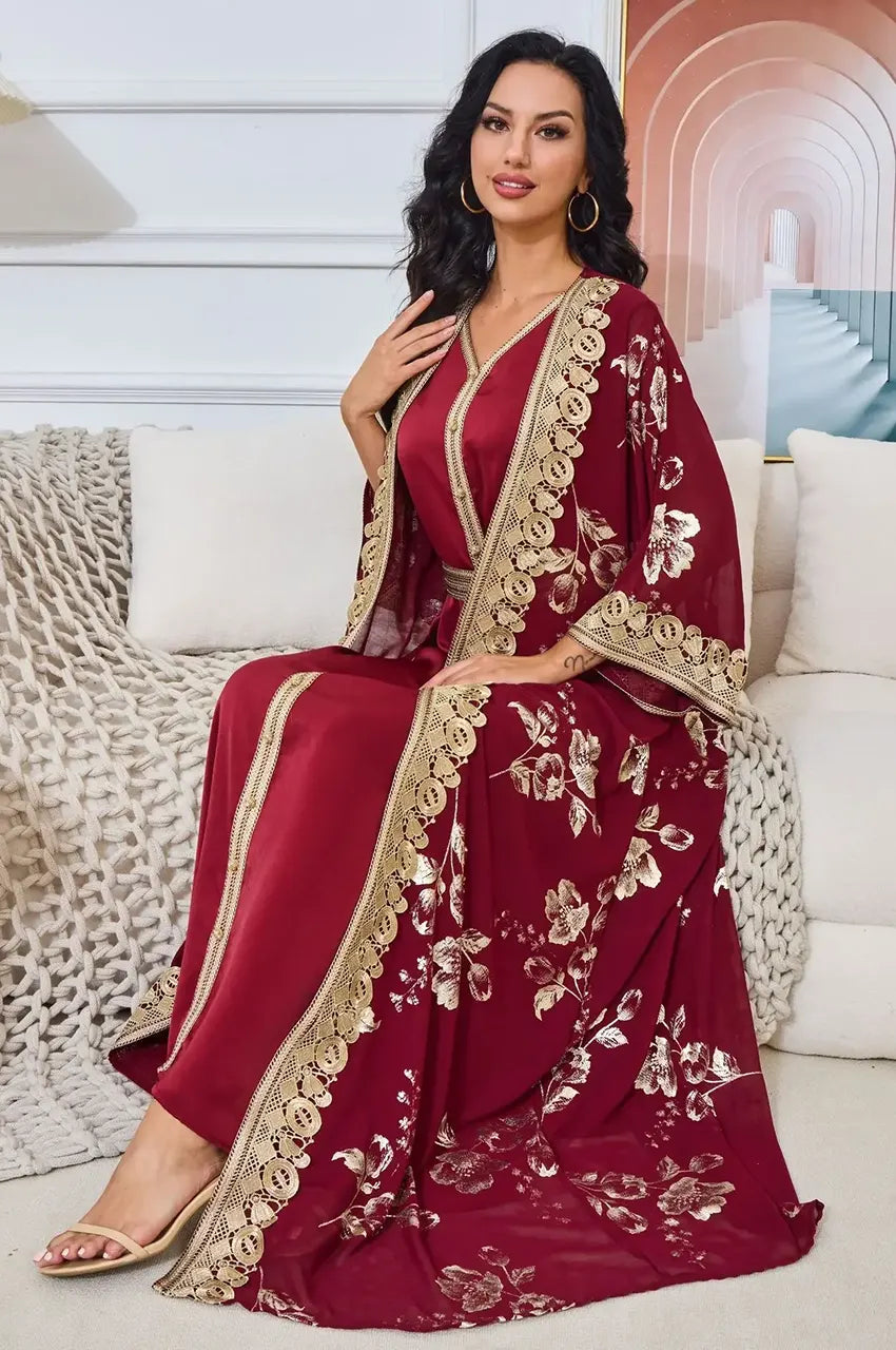 Seated model wearing Kalima red and gold open kaftan suitable for weddings.