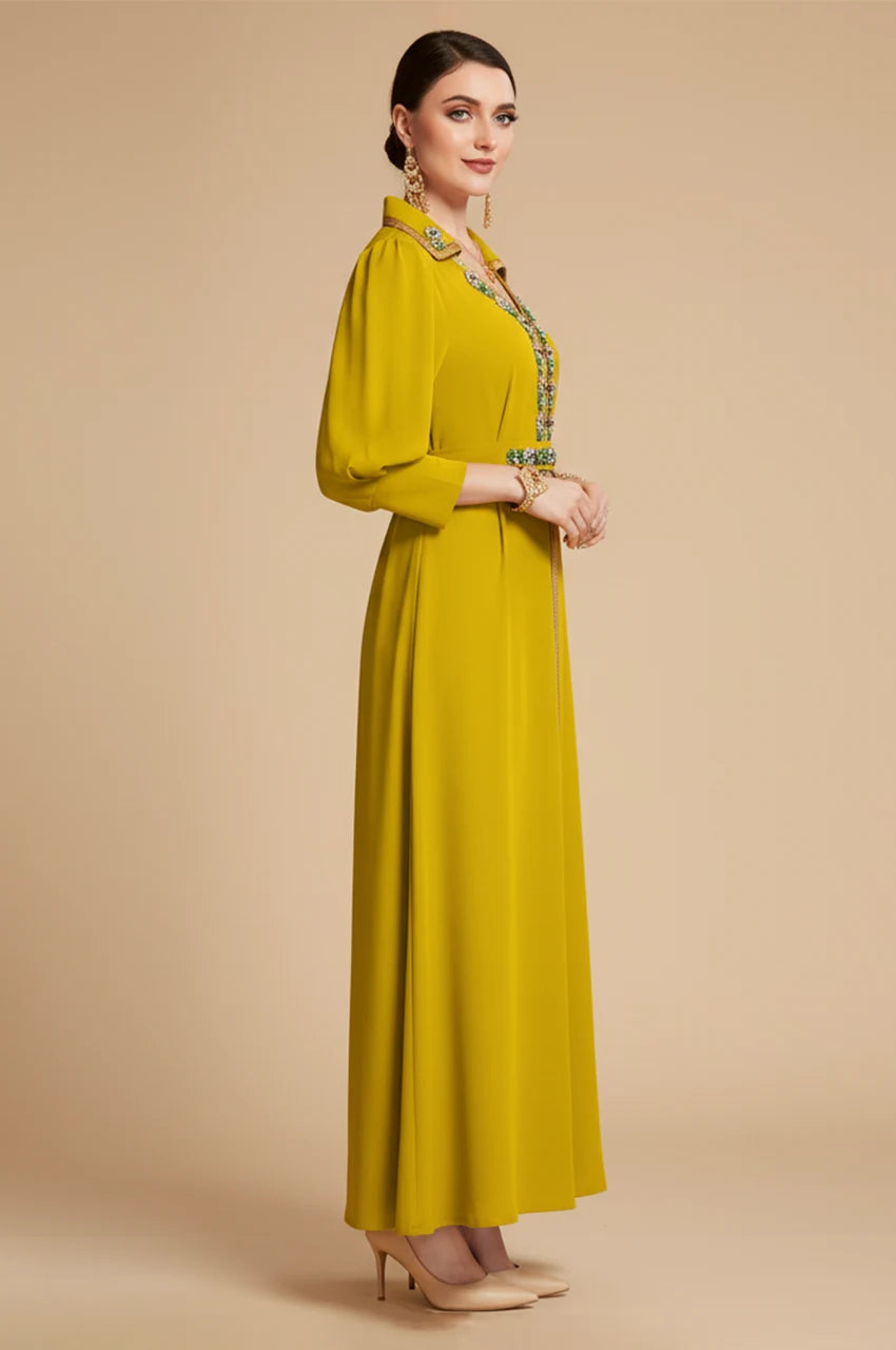 Side profile of the Karia green kaftan showing the volume of the bishop puff sleeves and the elegant A-line cut.