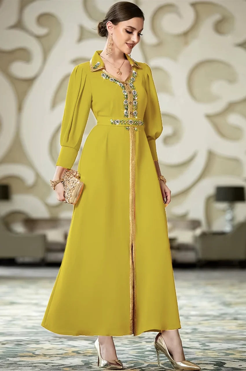 Front view of the Karia green maxi orient kaftan displaying the full length gold embroidery and crystal details.