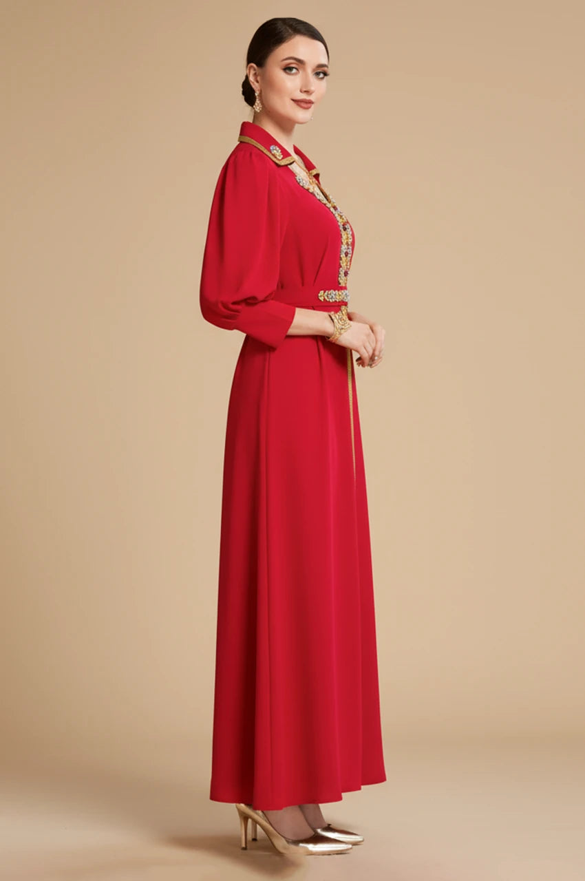 Side profile of the Karia red kaftan showing the volume of the bishop puff sleeves and the elegant A-line cut.