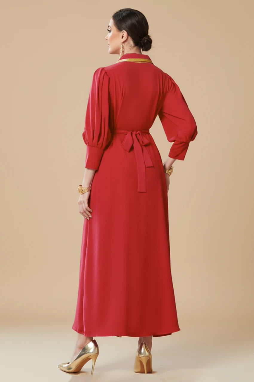 Back view of Karia ruby red modest evening gown featuring bishop sleeves and a matching tie-belt for a fitted silhouette.
