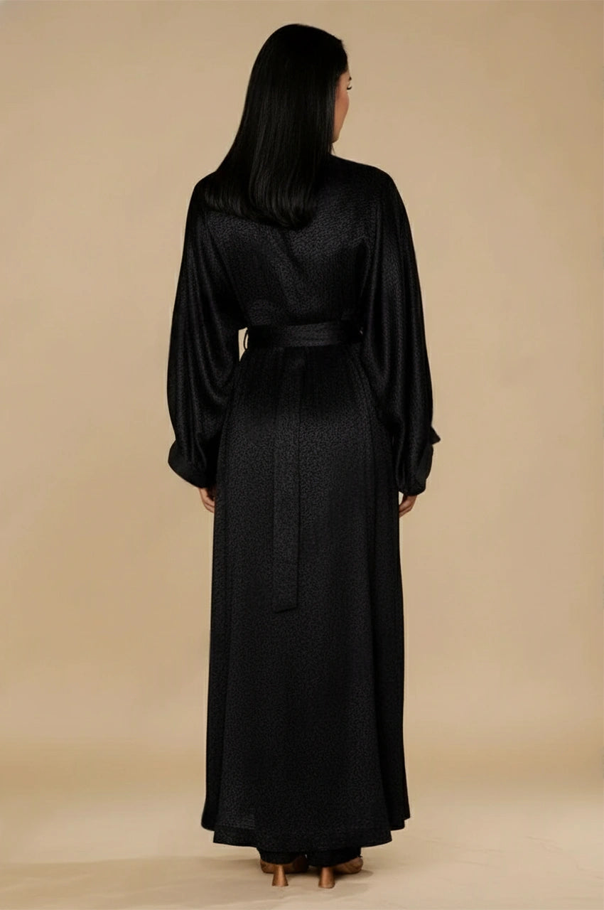 Metallic black kaftan with high neckline and flowy sleeves – back view of Kehlia evening kaftan
