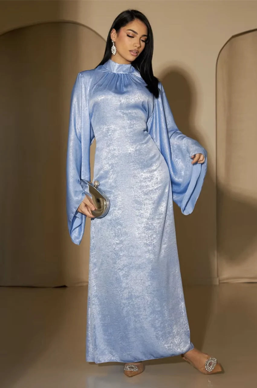 Kehlia metallic light blue kaftan in soft indoor lighting with shimmering satin texture