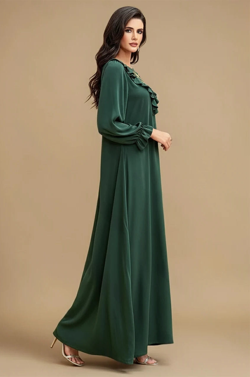 Side view of emerald embellished kaftan maxi dress with long sleeves and ruffle trim