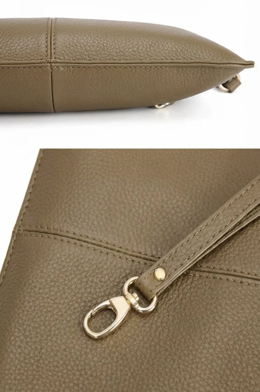 Macro detail of the pebbled leather texture and gold strap clip on the khaki crossbody clutch.
