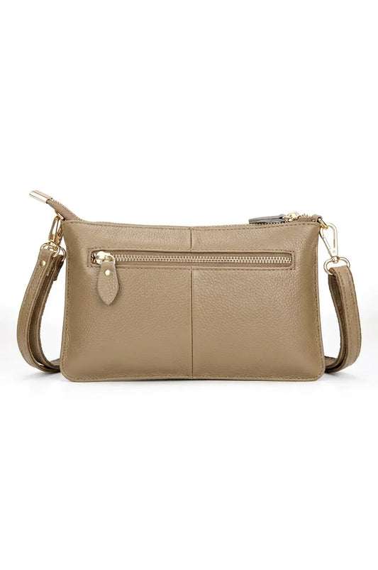 Back view of the khaki multi-pocket crossbody bag showing the convenient rear zipper compartment.