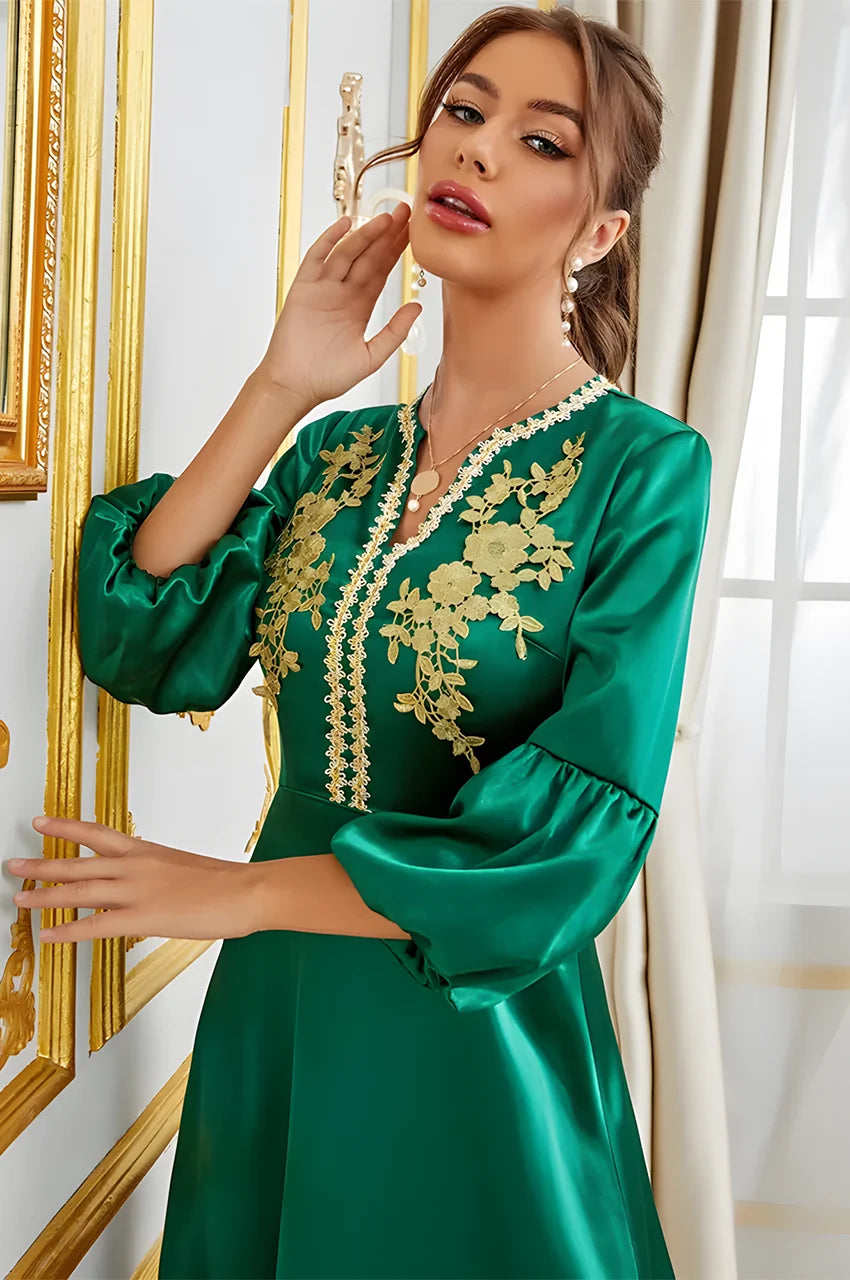 Close-up gold floral embroidery on Kiara emerald green kaftan