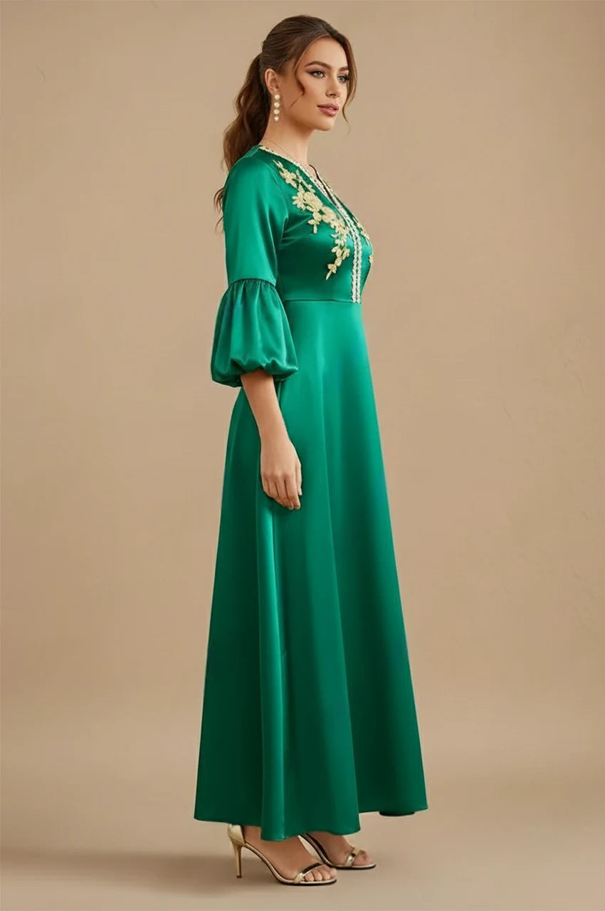 Kiara emerald green kaftan side view showcasing gold embroidered neckline and flared sleeves