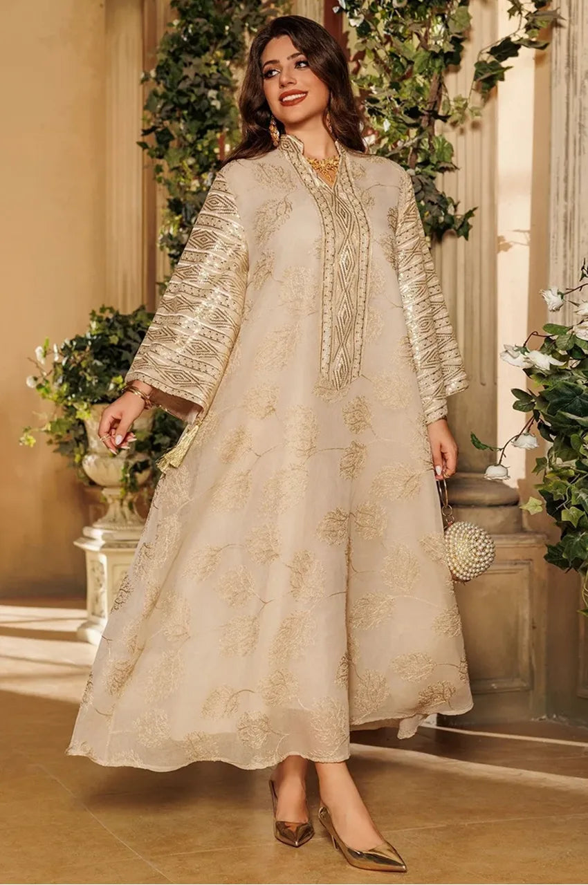 Elegant woman wearing beige Leena Persian kaftan while walking – luxurious gold details