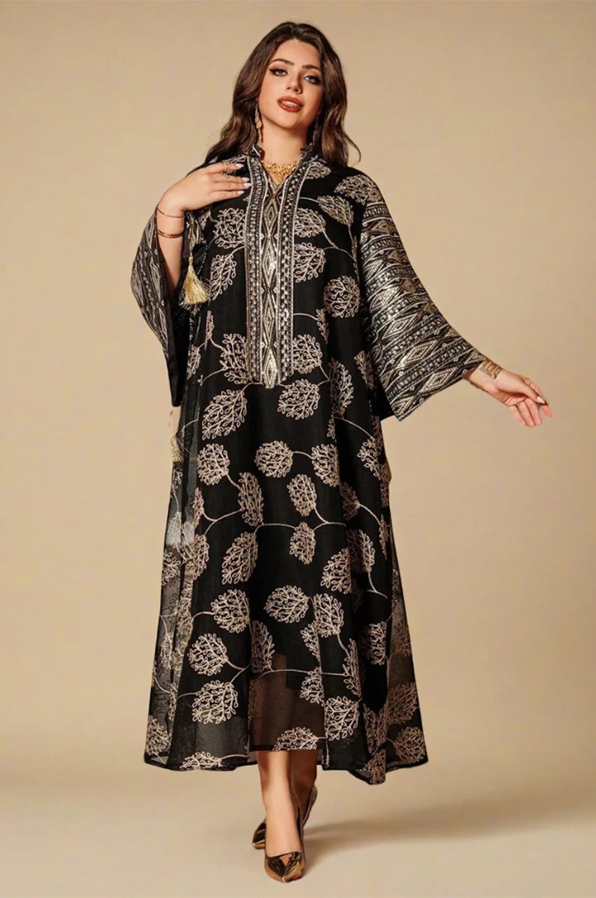 Elegant woman wearing black Leena Persian kaftan with wide embroidered sleeves
