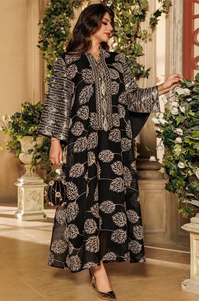 Black Persian kaftan Leena in luxury setting with gold handbag and floral backdrop
