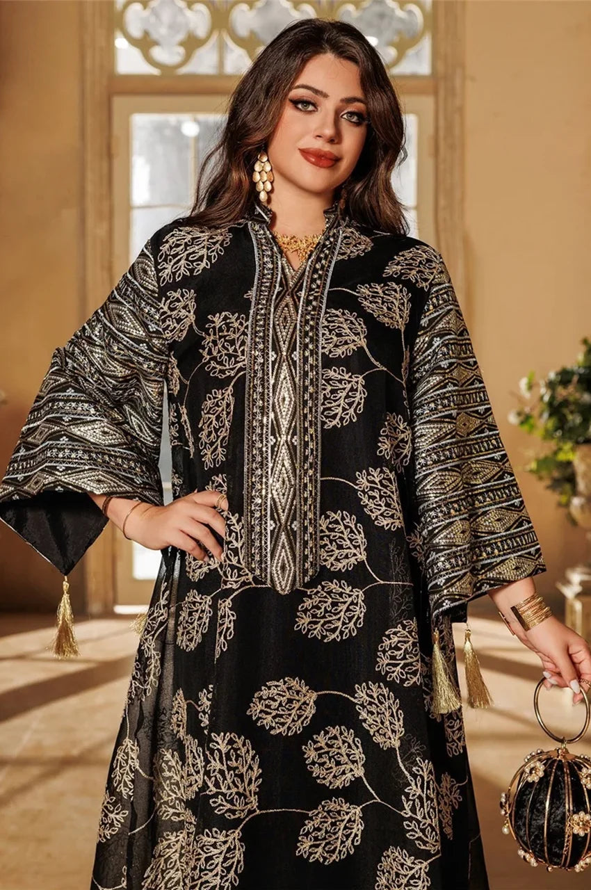 Detailed view of embroidered neckline and tassels on black Leena Persian kaftan
