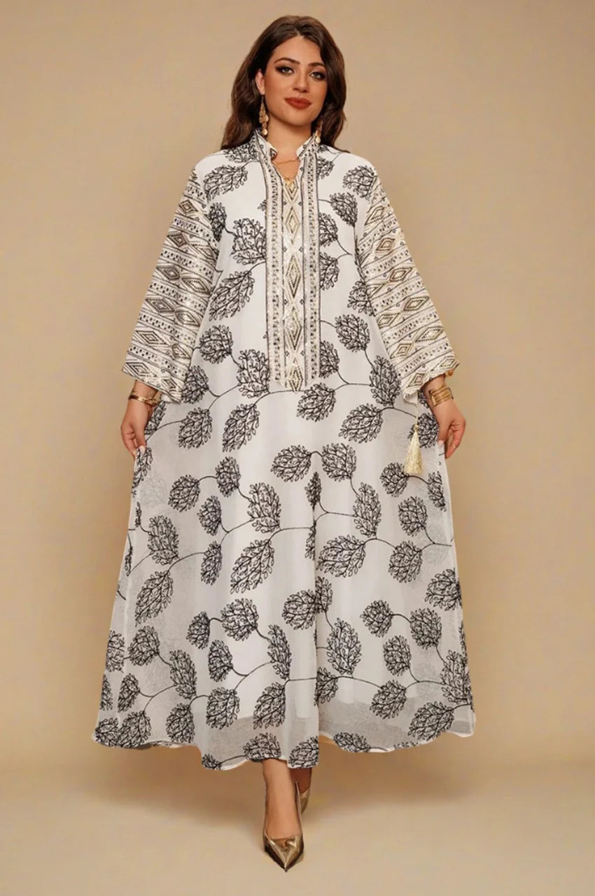 Full-length white Persian kaftan dress with wide sleeves and tassel details