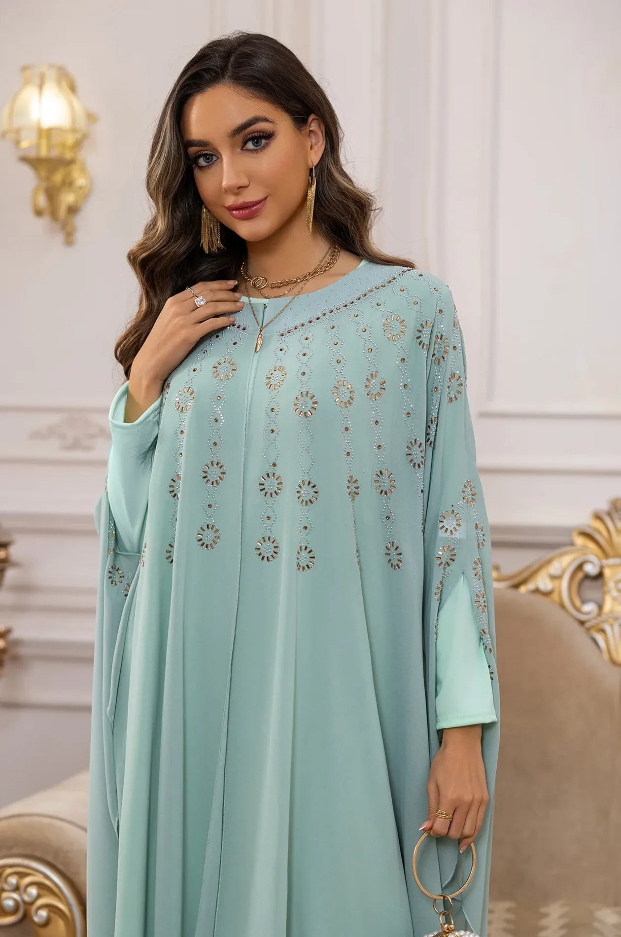 Close-up of the sunburst rhinestone motifs and neckline on the Light Green Cassia Kaftan.