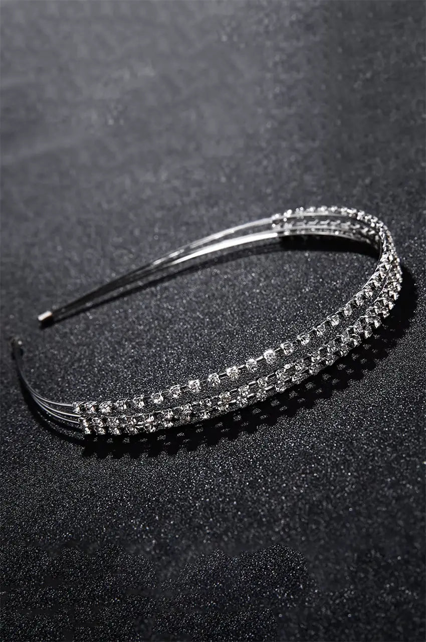 Side profile of thin silver rhinestone headband for evening wear.