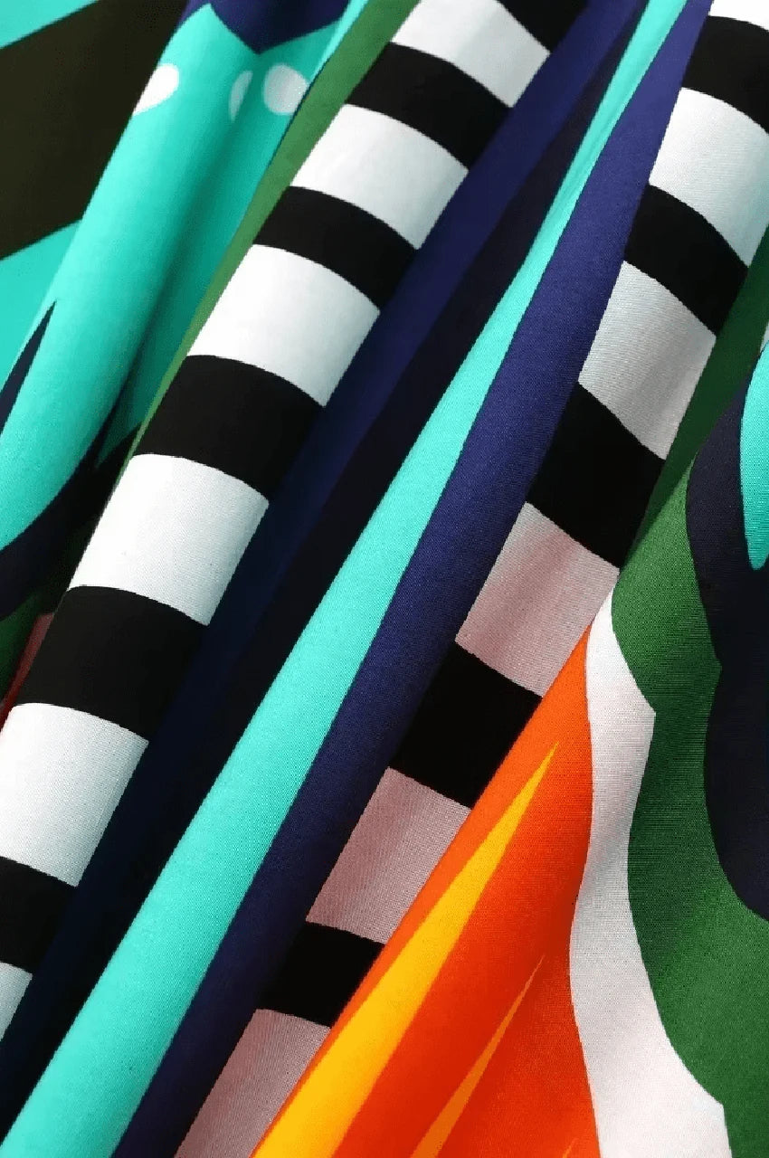 Close-up of gray boho kaftan fabric with butterfly-inspired abstract print