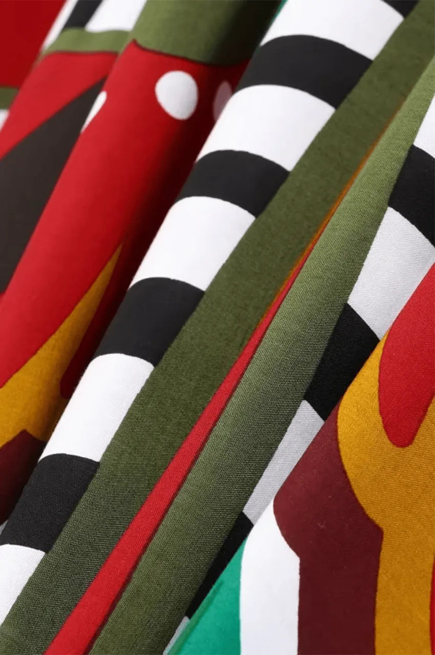 Close-up of red boho kaftan fabric with artistic butterfly print