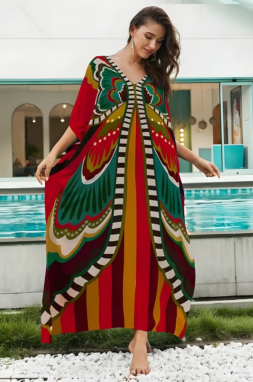 Model wearing red boho kaftan by poolside with artistic print