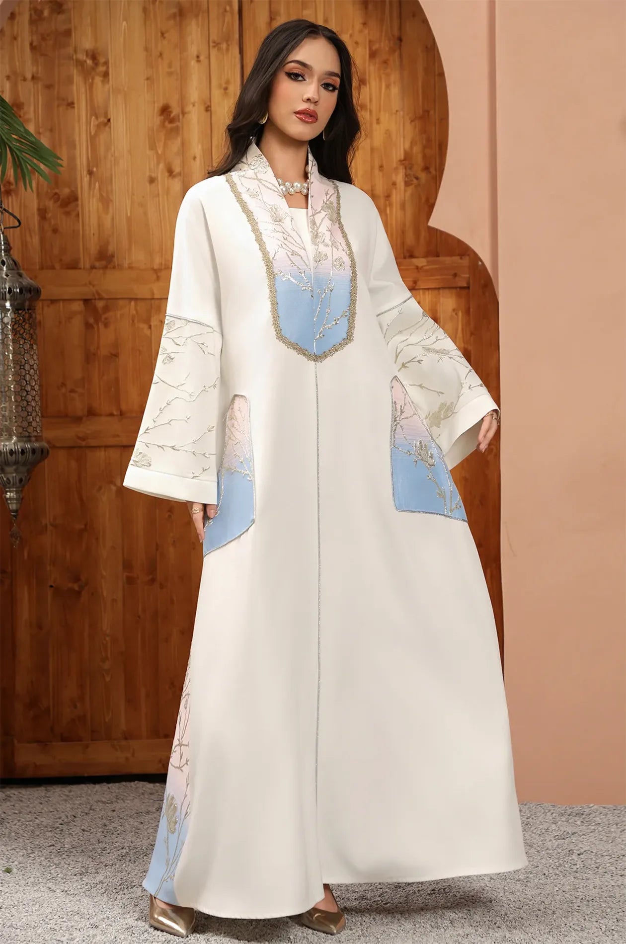 Close-up of the Liorra Light Blue Kaftan Ombre's upper bodice, showcasing the shimmering gold floral motifs and decorative braided neckline.