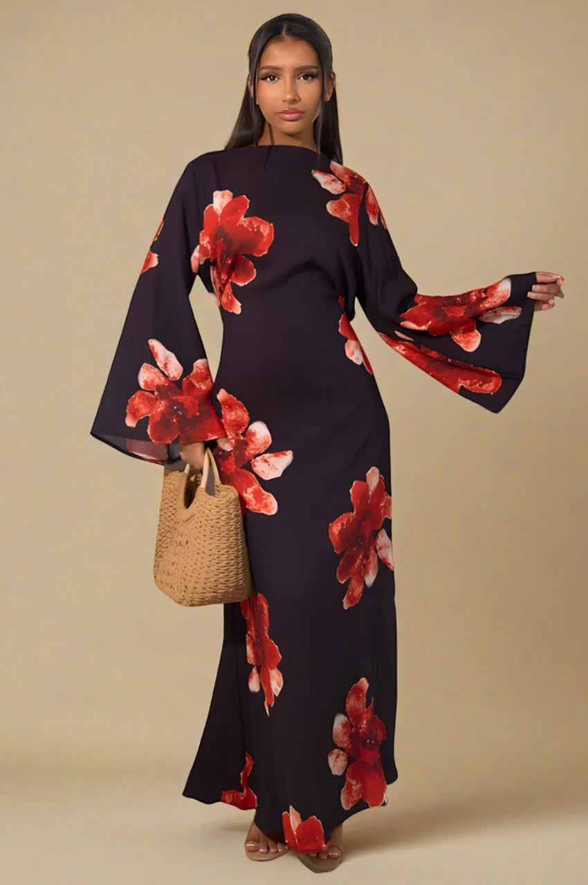 Front view of Liyana black floral print kaftan maxi dress with large red flowers and woven handbag