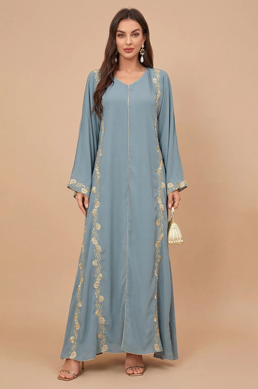 Front view of the Tahra long blue kaftan with gold embroidery by Naylara.