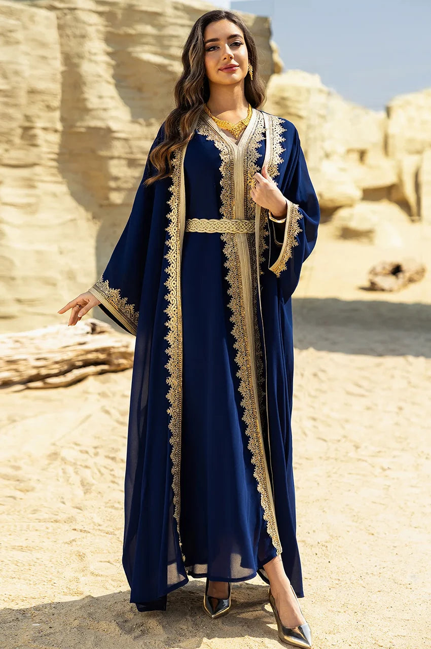 Royal blue long sheer kaftan styled for luxury resort wear in an outdoor desert setting.