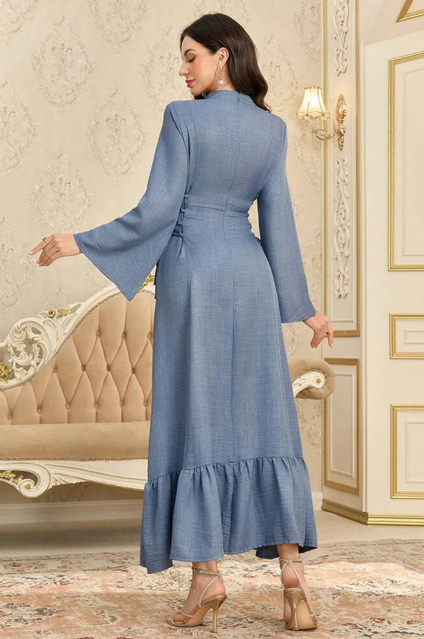 Detailed back angle of the Lumis dress showing the corset side ties and fabric texture.