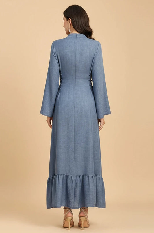 Back view of Lumis light blue kaftan showing the adjustable side-tie corset detailing and ruffled hem.