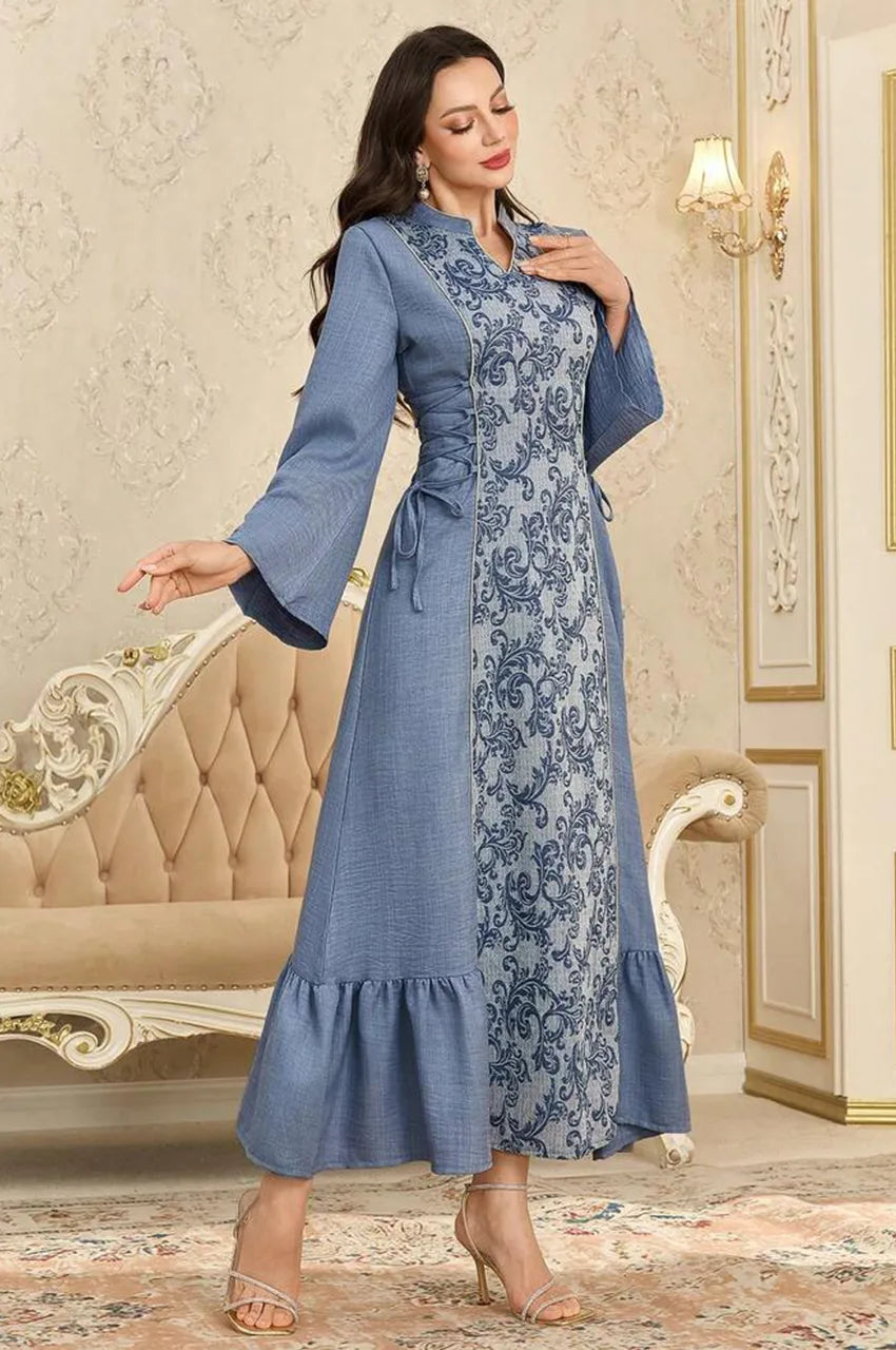 Model styling the Lumis light blue kaftan, showcasing the flow of the skirt and bell sleeves.