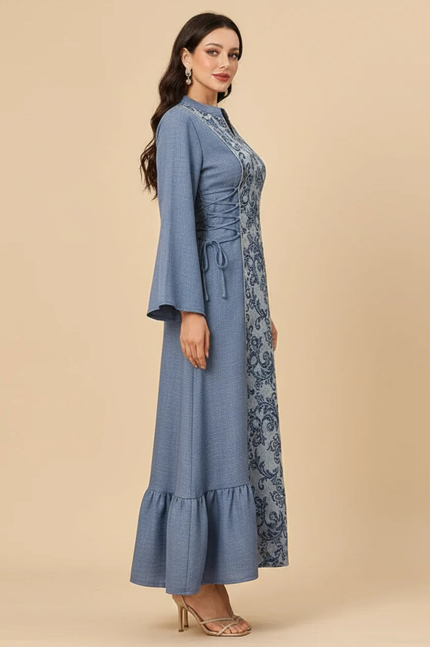 Side profile of the Lumis kaftan highlighting the wide bell sleeves and textured blue fabric.