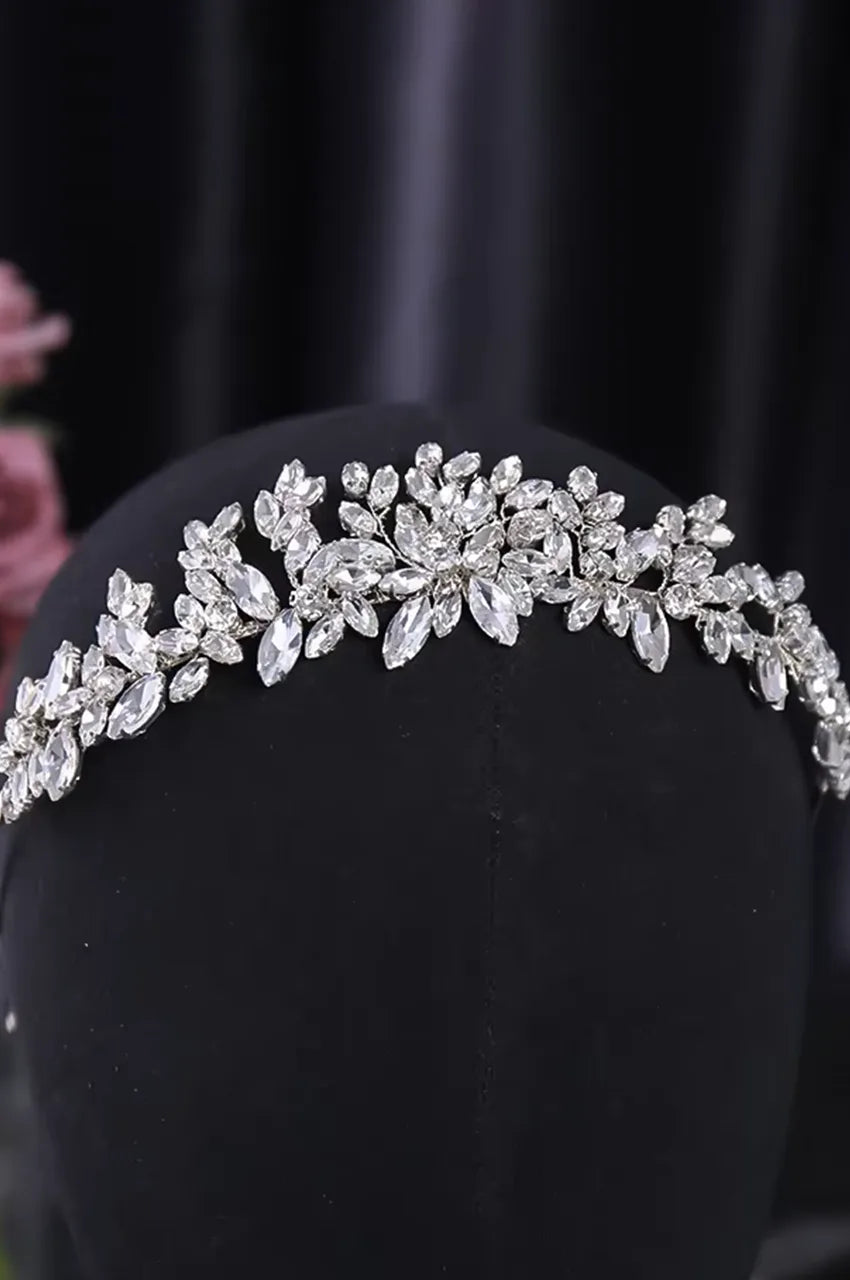 Silver crystal headpiece styled on black mannequin showing height and fit.