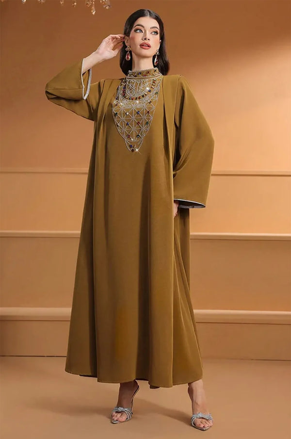 Model posing in the Rami crystal kaftan highlighting the fluid movement of the fabric.