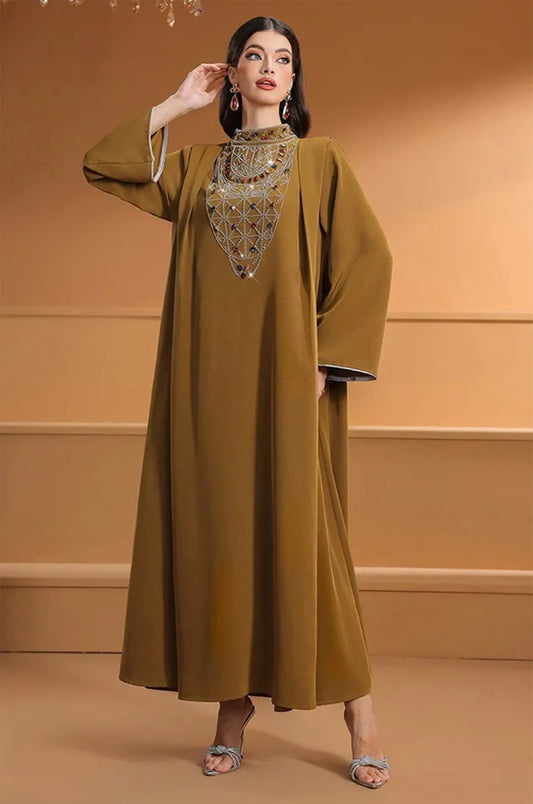 Model posing in the Rami crystal kaftan highlighting the fluid movement of the fabric.