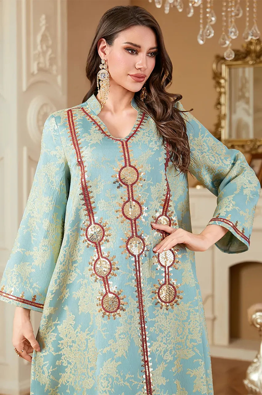 Waist-up shot of model in Riyah mint green kaftan highlighting the chest embroidery.